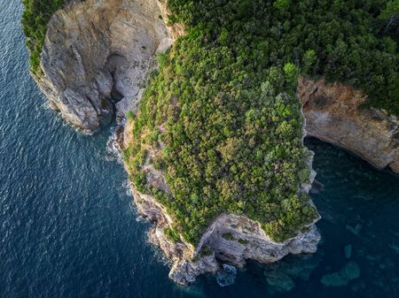 Aerial view of a steep cliff, unspoiled nature of the Montenegro coast. Sea caves and inlets alternate on the Mediterranean coast.の写真素材