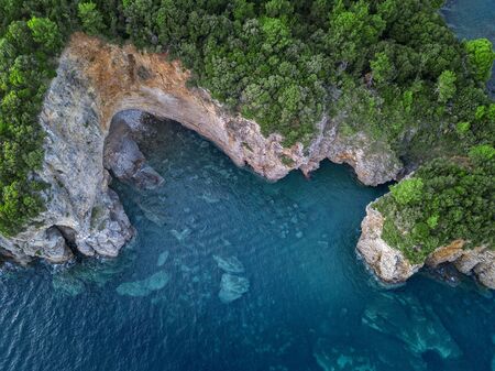 Aerial view of a steep cliff, unspoiled nature of the Montenegro coast. Sea caves and inlets alternate on the Mediterranean coast.の写真素材