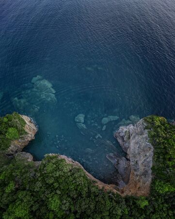 Aerial view of a steep cliff, unspoiled nature of the Montenegro coast. Sea caves and inlets alternate on the Mediterranean coast.の写真素材
