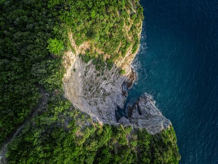 Aerial view of a steep cliff, unspoiled nature of the Montenegro coast. Sea caves and inlets alternate on the Mediterranean coast.の写真素材