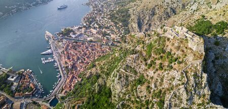 Aerial view of the Bay of Kotor, Boka. Old city of Kotor and the fortifications. The top of the mountain of St. John and the fortress. Tourism and cruise ships. The bay is the largest fjord in the Mediterranean. montenegroの写真素材