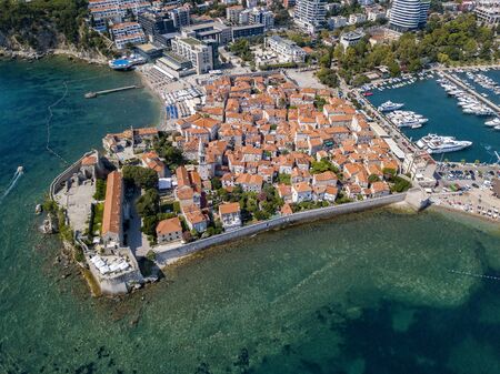 Aerial view of Budva, the old city (stari grad) of Budva, Montenegro. Jagged coast on the Adriatic Sea. Center of Montenegrin tourism, well-preserved medieval walled city, sandy beachesの写真素材