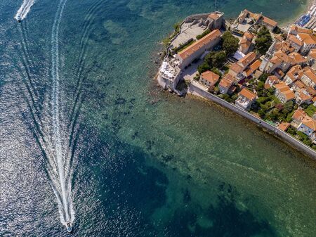 Aerial view of Budva, the old city (stari grad) of Budva, Montenegro. Jagged coast on the Adriatic Sea. Center of Montenegrin tourism, well-preserved medieval walled city, sandy beachesの写真素材
