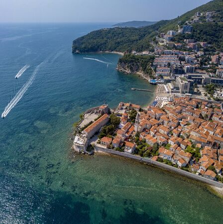 Aerial view of Budva, the old city (stari grad) of Budva, Montenegro. Jagged coast on the Adriatic Sea. Center of Montenegrin tourism, well-preserved medieval walled city, sandy beachesの写真素材