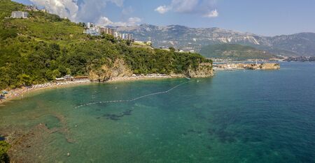 Aerial view of Mogren beach (two sandy beaches) and the old city (stari grad) of Budva, Montenegro. Jagged coast on the Adriatic Seaの写真素材