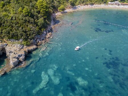 Aerial view of Mogren beach (two sandy beaches) and the old city (stari grad) of Budva, Montenegro. Jagged coast on the Adriatic Seaの写真素材
