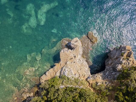 Aerial view of Mogren promontory between the Mogren beaches. Budva. Montenegro. Jagged coasts with sheer cliffs overlooking the transparent sea. Wild nature and Mediterranean maquisの写真素材