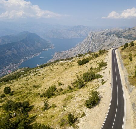 Aerial view of the Bay of Kotor, Boka. Scenic road overlooking the bay of the Kotor fjord. Winding roads to discover Montenegro. Tourism and cruise shipsの写真素材