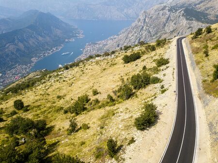 Aerial view of the Bay of Kotor, Boka. Scenic road overlooking the bay of the Kotor fjord. Winding roads to discover Montenegro. Tourism and cruise shipsの写真素材