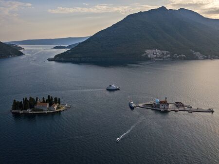 Aerial view of Our Lady of the Rocks and Sveti Dorde, the two islets off the coast of Perast in the Bay of Kotor, Montenegro.の写真素材