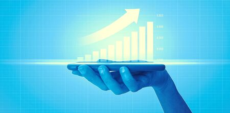 Businesswoman holding a mobile phone and showing holographic graphs and stock market statistics gain profits. Concept of growth planning and business strategy. Good economy, digital screen. HUDの写真素材