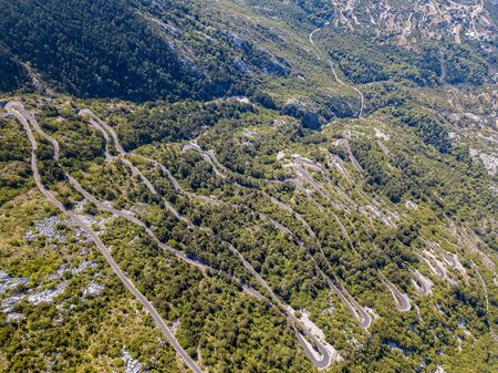 Aerial view of one of the most winding roads in the world, near Kotor, Montenegro. Set in a breathtaking natural landscape.の写真素材