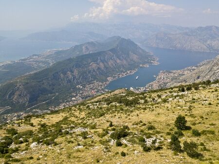 Aerial view of the Bay of Kotor, Boka. Scenic road overlooking the bay of the Kotor fjord. Winding roads to discover Montenegro. Tourism and cruise shipsの写真素材