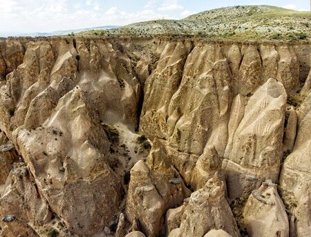 Aerial view of Goreme National Park, Goreme Tarihi Milli Parki, Turkey. The typical rock formations of Cappadocia with fairy chimneys and desert landscape. Travel destinations, holidays and adventureの写真素材