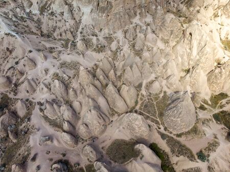 Aerial view of Goreme National Park, Tarihi Milli Parki, Turkey. The typical rock formations of Cappadocia with fairy chimneys and desert landscape. Travel destinations, holidays and adventureの写真素材