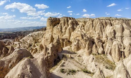 Aerial view of Goreme National Park, Tarihi Milli Parki, Turkey. The typical rock formations of Cappadocia with fairy chimneys and desert landscape. Travel destinations, holidays and adventureの写真素材