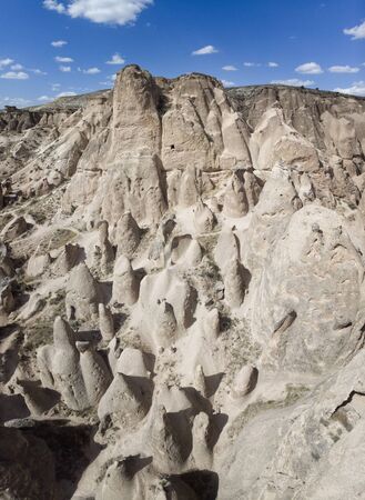 Aerial view of Goreme National Park, Tarihi Milli Parki, Turkey. The typical rock formations of Cappadocia with fairy chimneys and desert landscape. Travel destinations, holidays and adventureの写真素材