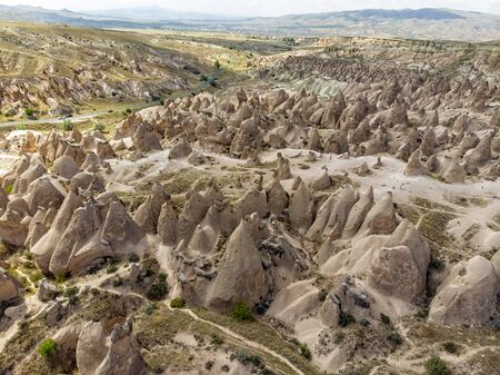 Aerial view of Goreme National Park, Tarihi Milli Parki, Turkey. The typical rock formations of Cappadocia with fairy chimneys and desert landscape. Travel destinations, holidays and adventureの写真素材