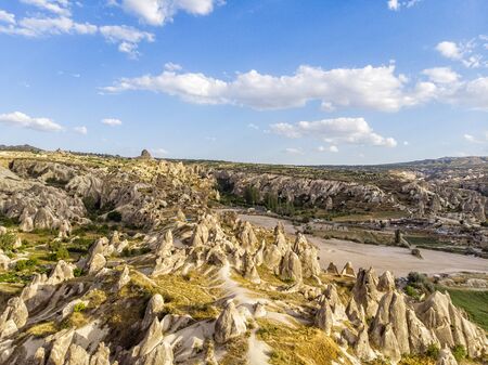 Aerial view of Goreme National Park, Tarihi Milli Parki, Turkey. The typical rock formations of Cappadocia with fairy chimneys and desert landscape. Travel destinations, holidays and adventureの写真素材