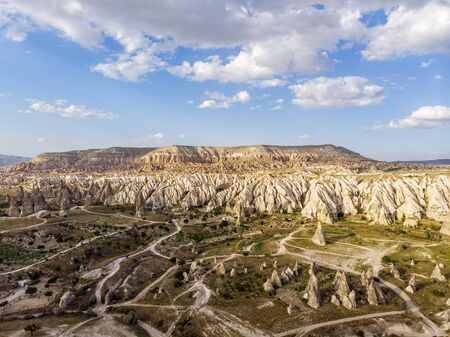 Aerial view of Goreme National Park, Tarihi Milli Parki, Turkey. The typical rock formations of Cappadocia with fairy chimneys and desert landscape. Travel destinations, holidays and adventureの写真素材