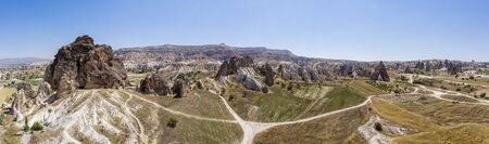 Aerial view of Goreme National Park, Tarihi Milli Parki, Turkey. The typical rock formations of Cappadocia with fairy chimneys and desert landscape. Travel destinations, holidays and adventureの写真素材