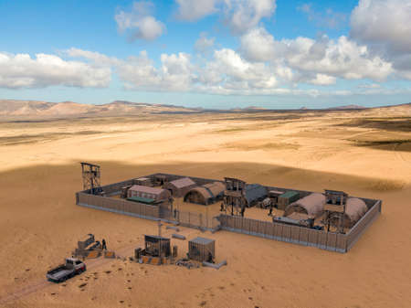 Military compound in the middle east, aerial view of a military base. Guard towers and reinforced concrete fence. Defense of terrorist attacks, 3d renderの写真素材