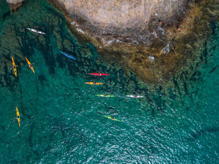 Aerial view of canoes sailing near the rugged coastlines and beaches of Lanzarote, Spain, Canaries. Explore the island. Bathers on the beach and in the Atlantic Ocean. Papagayoの写真素材