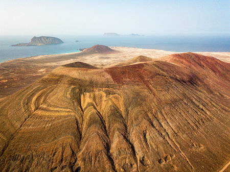 Aerial view of Chinijo Archipelago of La Graciosa, Lanzarote, Canary Islands. Spain. La Aguja Grande mountain. Outdoor trekking route. Explore and adventure.の写真素材