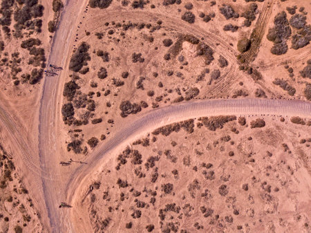 Aerial view of people cycling on a dirt path in the island of La Graciosa, Lanzarote, Canary Islands. Spain. Outdoor trekking route. Explore and adventure.の写真素材