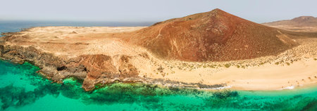 Aerial view of the Playa de las Conchas and mountain Bermeja, La Graciosa island in Lanzarote, Canary island. Spain. Ocean view and sand beachの写真素材