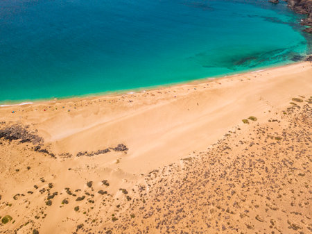 Aerial view of the jagged shores and beaches of La Graciosa island. Bathers on the beach of las Conchas. The main archipelago island Chinijo, a mile northwest of Lanzarote. Canary island. Spain. Oceanの写真素材