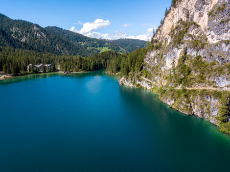 Aerial view of the Lake Braies, Pragser Wildsee is a lake in the Prags Dolomites in South Tyrol, Italy. People walking and trekking along the paths that run along the lakeの写真素材