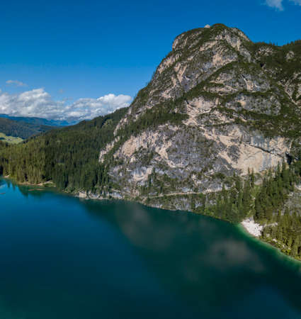 Aerial view of the Lake Braies, Pragser Wildsee is a lake in the Prags Dolomites in South Tyrol, Italy. People walking and trekking along the paths that run along the lakeの写真素材