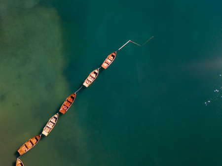 Aerial view of the Lake Braies, Pragser Wildsee is a lake in the Prags Dolomites in South Tyrol, Italy. View of rowboats moored in lineの写真素材