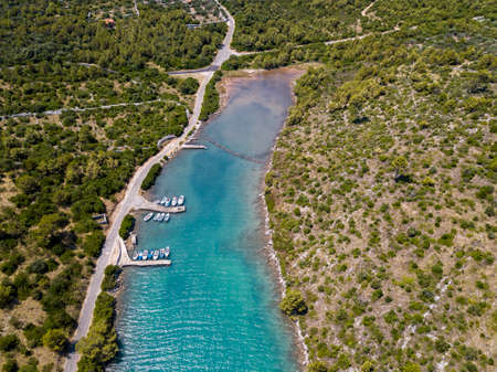 Aerial view of fishing boats moored near the pier on the island of Dugi Otok in front of the city of Zadar, Croatia. Vacation and tourismの写真素材
