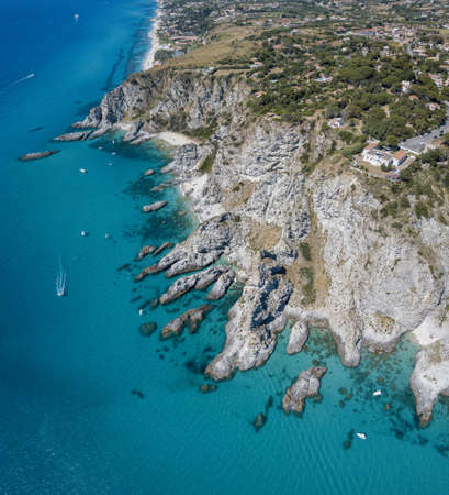Aerial view of Capo Vaticano, Calabria, Italy. Lighthouse and promontory. Rocks overlooking the sea. Praia I Focu beach and A Ficara beach. Boats and bathers and crystal clear sea. Coast of the Godsの写真素材
