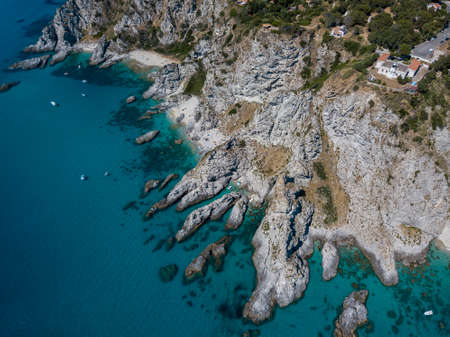Aerial view of moored boats floating on a transparent sea. Scuba diving and summer holidays. Capo Vaticano, Calabria, Italy. Promontory.の写真素材