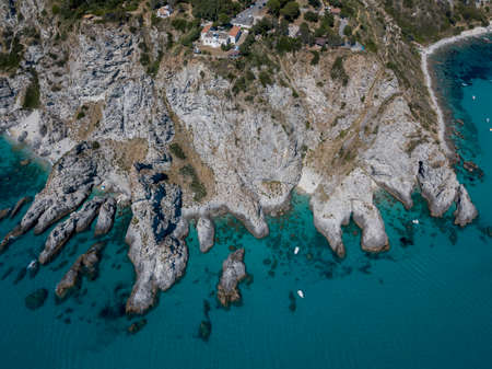 Aerial view of moored boats floating on a transparent sea. Scuba diving and summer holidays. Capo Vaticano, Calabria, Italy. Promontory.の写真素材