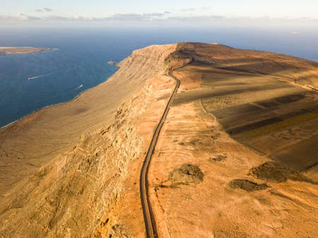 Aerial view from the north tip of the island of Lanzarote, view of the road leading to the Mirador del Rio. Jagged coasts and cliffs overlooking the ocean. Canary Islands, Spainの写真素材