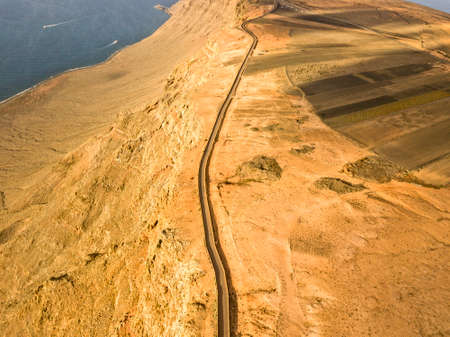 Aerial view from the north tip of the island of Lanzarote, view of the road leading to the Mirador del Rio. Jagged coasts and cliffs overlooking the ocean. Canary Islands, Spainの写真素材
