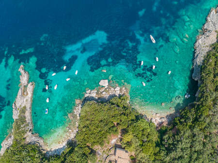 Aerial view of the rocks between the beach of Klimatia Beach and Limni beach on the island of Corfu. Coastline. Transparent and crystalline water, moored boats and bathers. Vacatioの写真素材