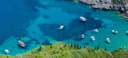 Aerial view of boats close to Limni Beach Glyko, on the island of Corfu. Greece. Where the two beaches are connected to the mainland providing a wonderful scenery. Unique double beのeditorial素材