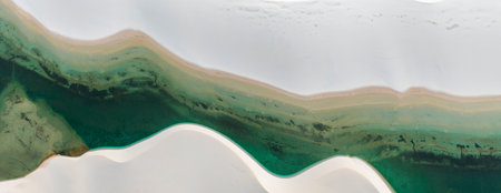Aerial view of Lencois Maranhenses. White sand dunes with pools of fresh and transparent water....