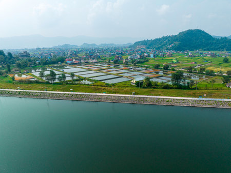 Aerial view of Begnas Lake area, houses and homes surrounded by rice fields, Begnas with a number of resorts is a popular destination for tourists visiting Pokhara, Nepal 10-7-2023の写真素材