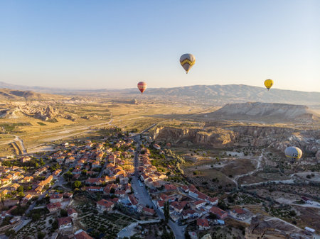 Aerial view of hot air balloons at dawn against the light, flying over the valleys of Cappadocia, 07-08-2019. Turkeyのeditorial素材