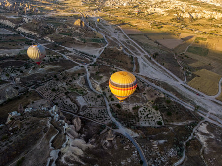 Aerial view of hot air balloons at dawn against the light, flying over the valleys of Cappadocia, 07-08-2019. Turkeyの写真素材