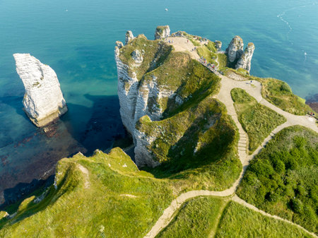 Aerial view of Etretat cliffs and the Atlantic ocean. Chalk cliffs and three natural arches. Panoramic path to admire the coast. Normandy region of Northwestern France. 06-26-2024の写真素材