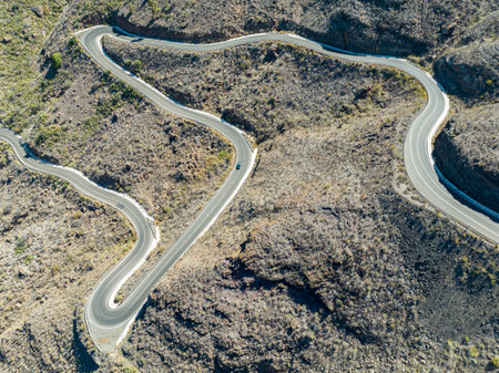 Aerial view of winding roads on the west coast of Gran Canaria, the least urbanized coast. Province of Mogan. Desert land with little vegetationの写真素材