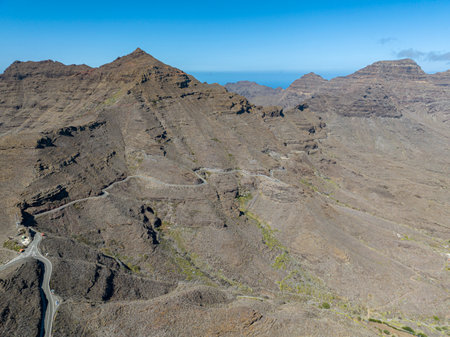 Aerial view of winding roads on the west coast of Gran Canaria, the least urbanized coast. Province of Mogan. Desert land with little vegetationの写真素材