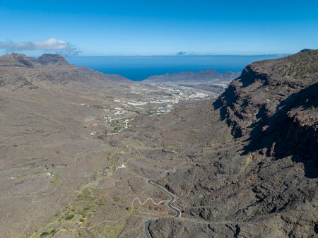 Aerial view of winding roads on the west coast of Gran Canaria, the least urbanized coast. Province of Mogan. Desert land with little vegetationの写真素材